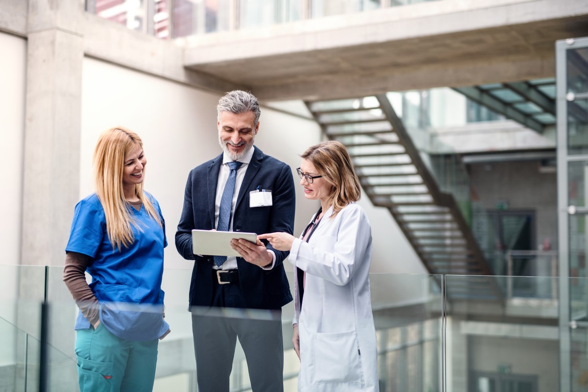 Medical professionals having conversation with a financial advisors for doctors